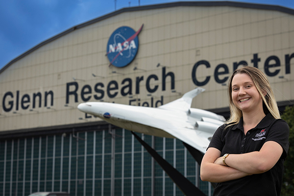 Miami student poses in front of the NASA Glenn Research Center