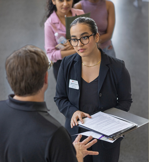 a student talking with a company rep at career fair