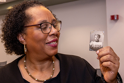 Melanie Walker holding a photo of her great-grandmother, Nellie Craig Walker, Miami University's first Black graduate