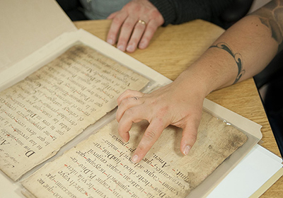 two people analyzing archival materials