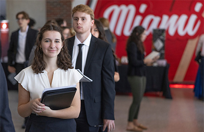 students waiting in line to talk with recruiters at career fair