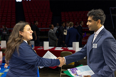 Two individuals shaking hands