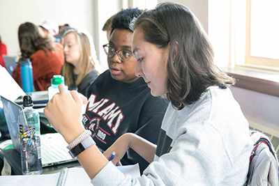 two students working together at a desk