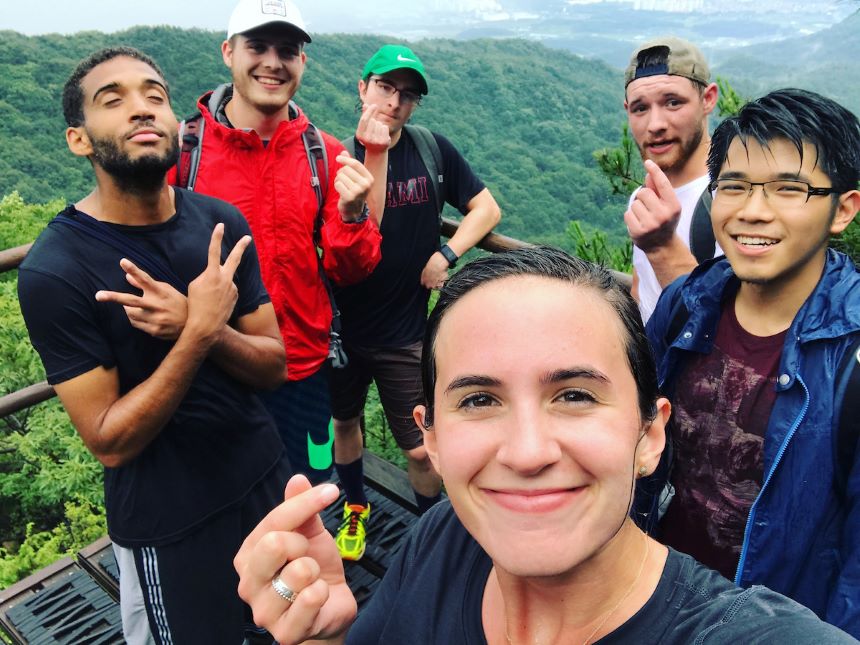 Six students atop a mountain in South Korea