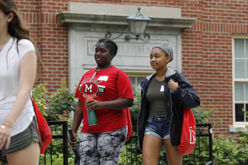 Students walking on campus in the spring season.