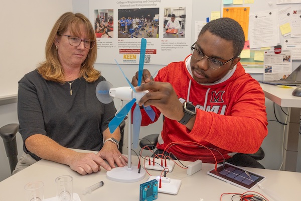 Professor and student with a turbine model.