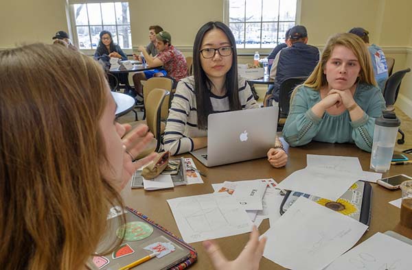 Three students working together at a table