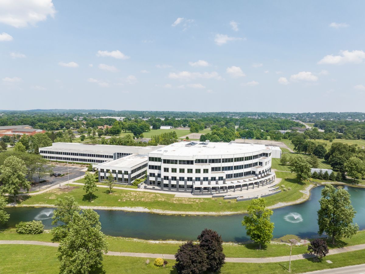 Exterior of Miami University's advanced manufacturing hub, a round white building with many windows surrounded by trees