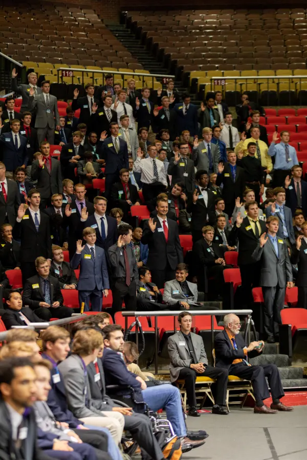 Group shot of boys taking oath during ceremony.