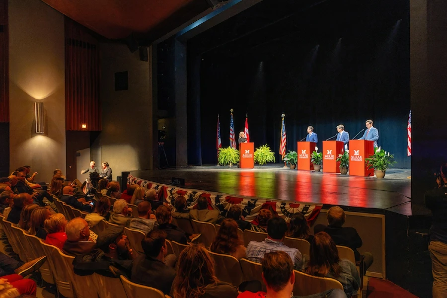 Civic forum held on campus with three students and moderator.
