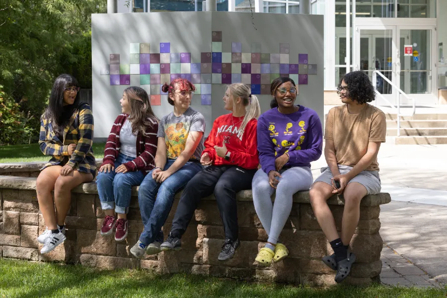 students sitting outside