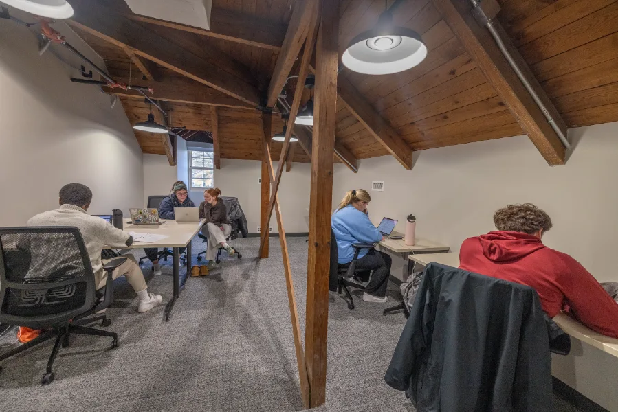 interior work space at College at Elm where multiple people are working at desks