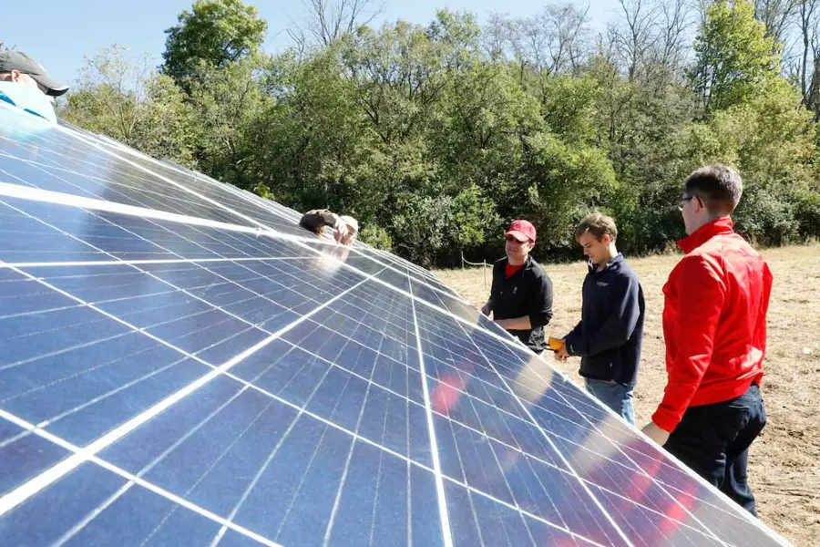 student working on a solar panel
