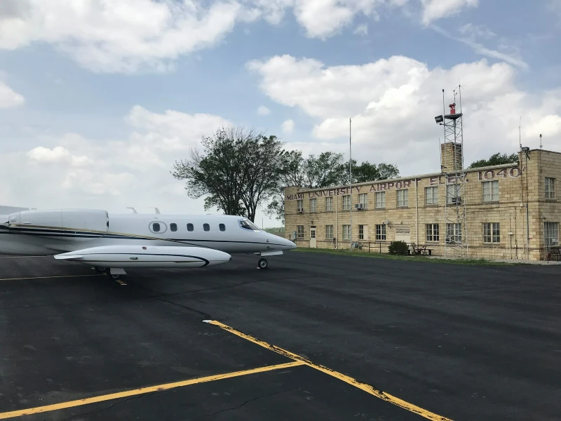 a plane in front of the miami airport hanger