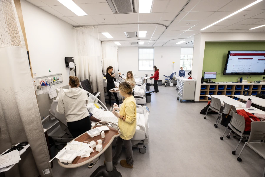 Staged medical clinic with students and professors working on patients.