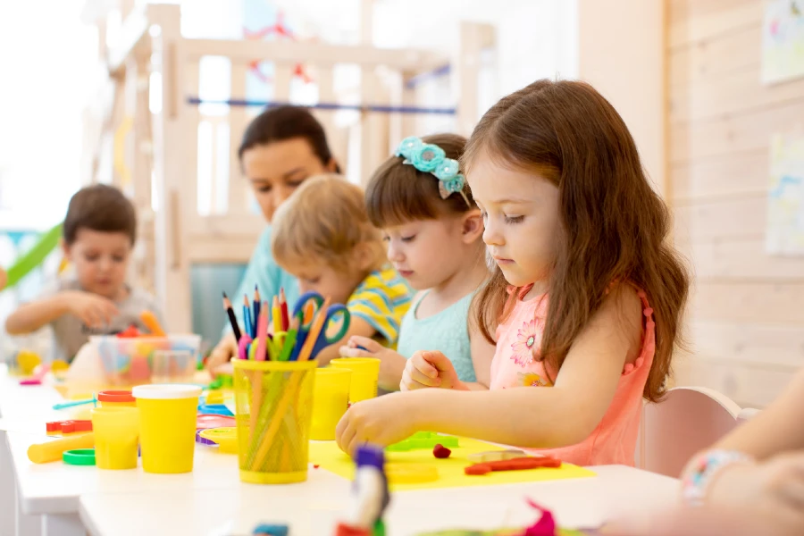 Young students working at a table using playdoh.