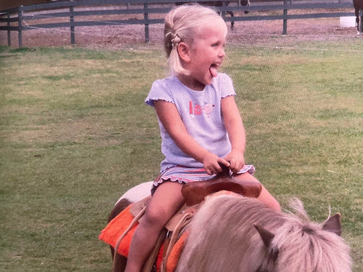 Hannah Leon riding a small pony at a young age