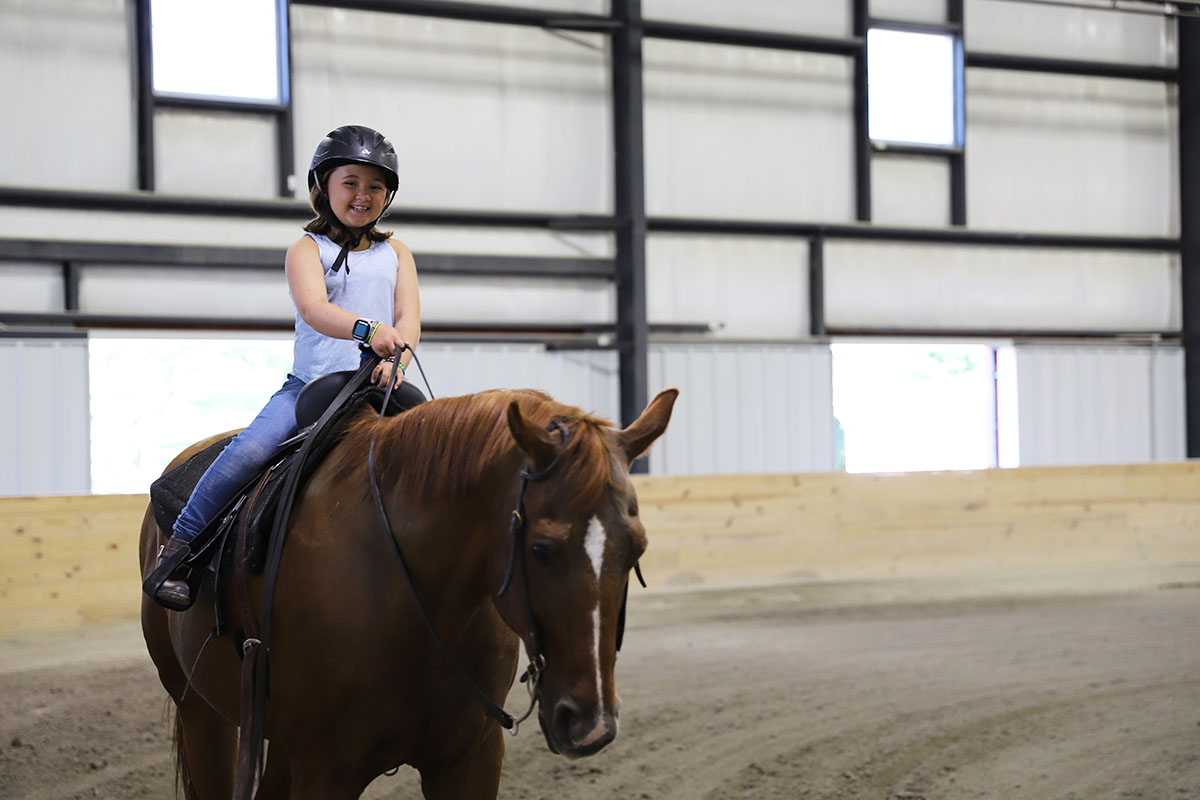 Child riding a horse