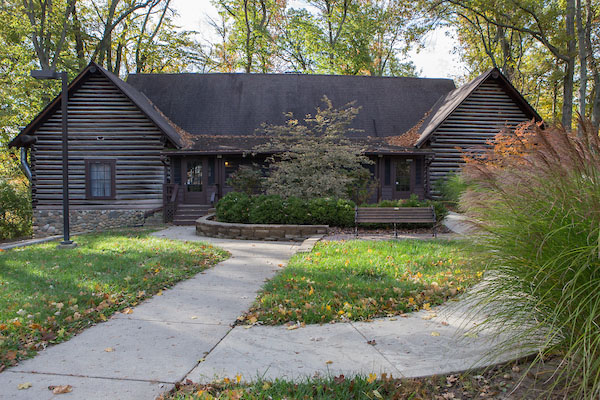 Western lodge, a wood cabin, surrounded by trees