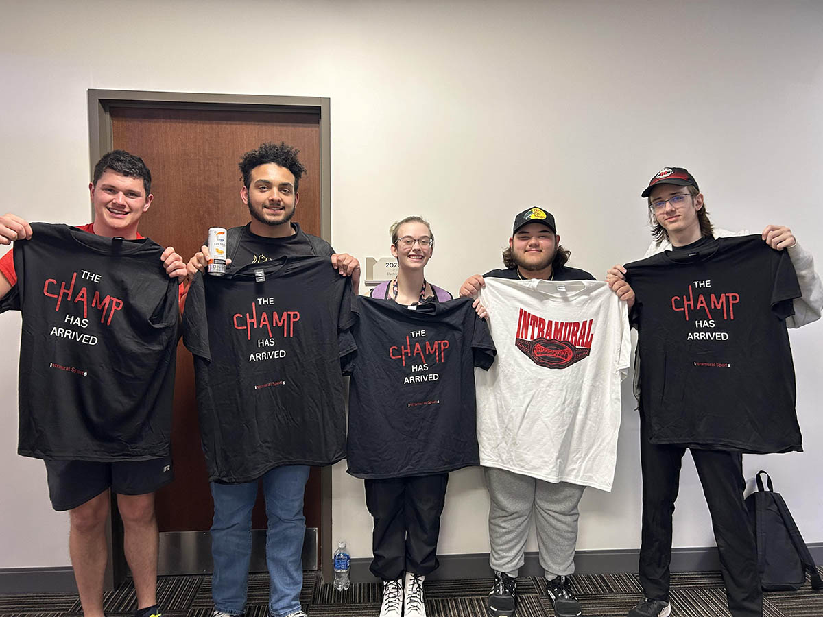 students holding up intramural esports shirts