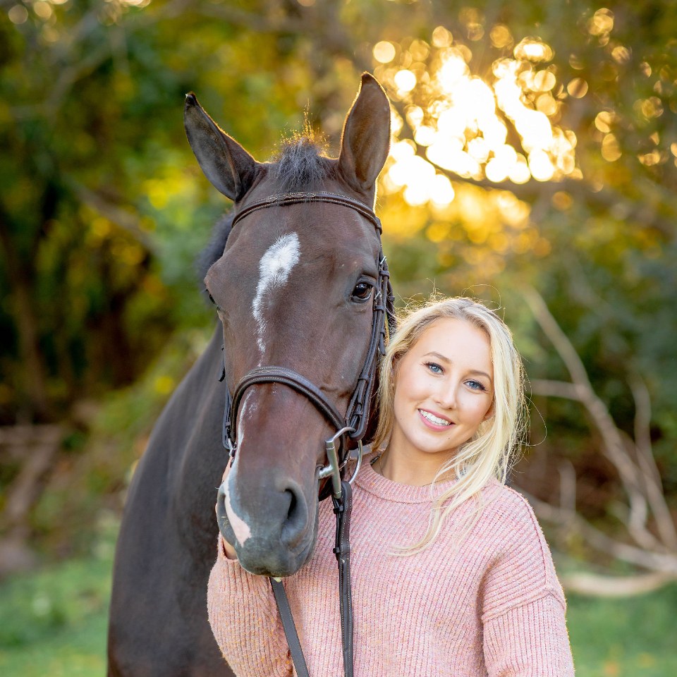 Audrey Yerkes posing with her horse outside