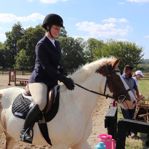 Eva Hollingsworth riding a horse outside