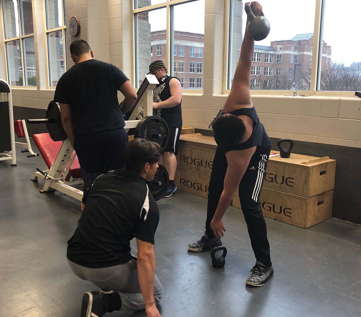 A small group of Miami students working with a personal trainer