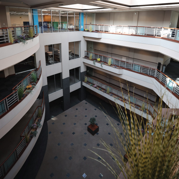 Advanced Manufacturing Workforce and Innovation Hub atrium that interconnects 5 buildings and features four-story with skylights.