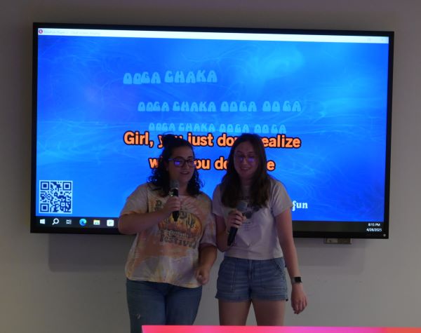 Two women singing karaoke