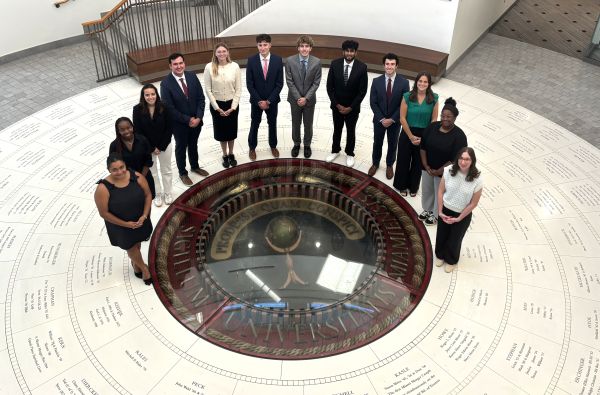 people standing around the 3D Seal in a semicircle