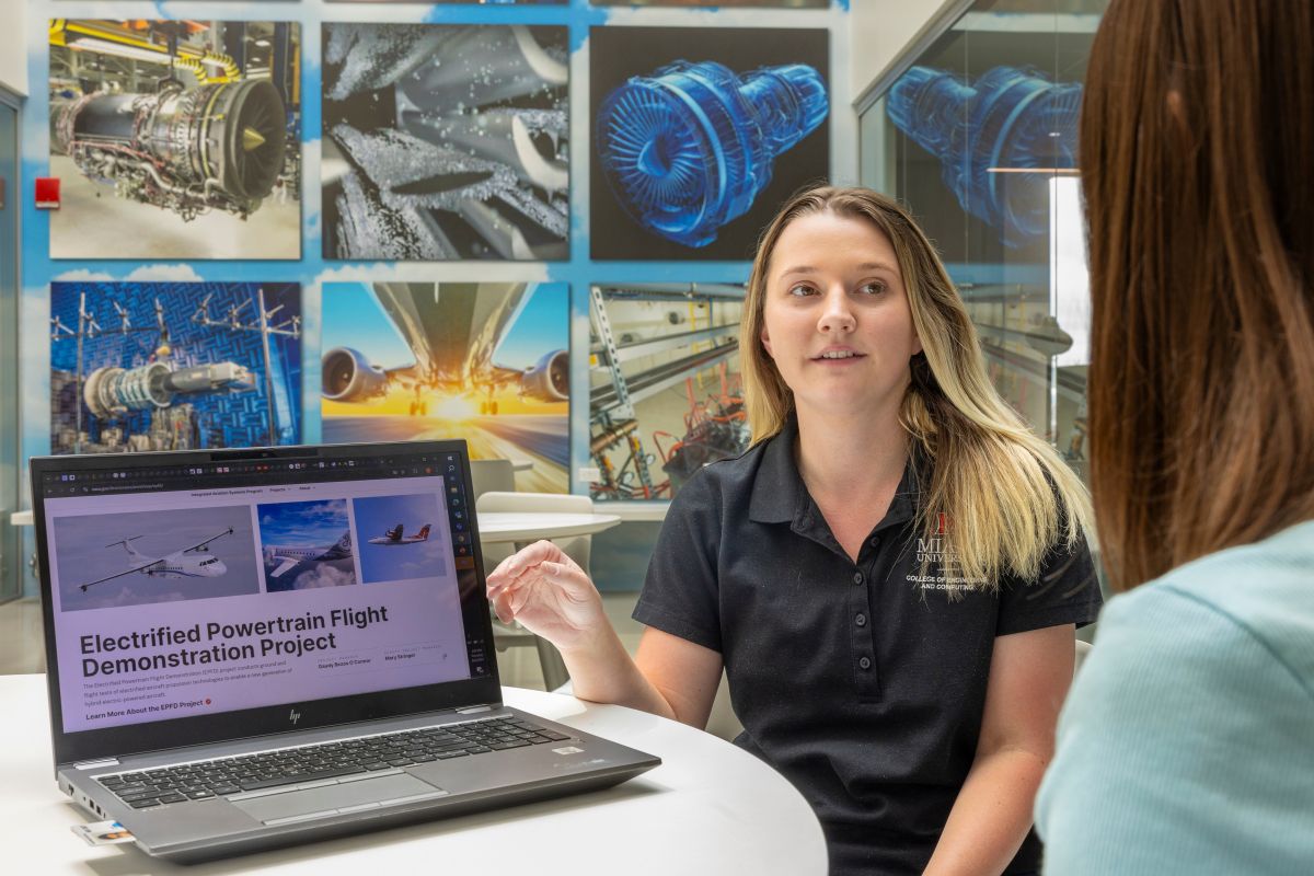 A student intern at NASA presents a project to a staff member.