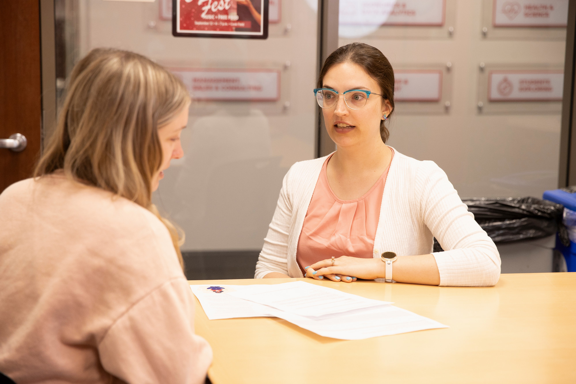 A career advisor reviews a resume and cover letter with a student.