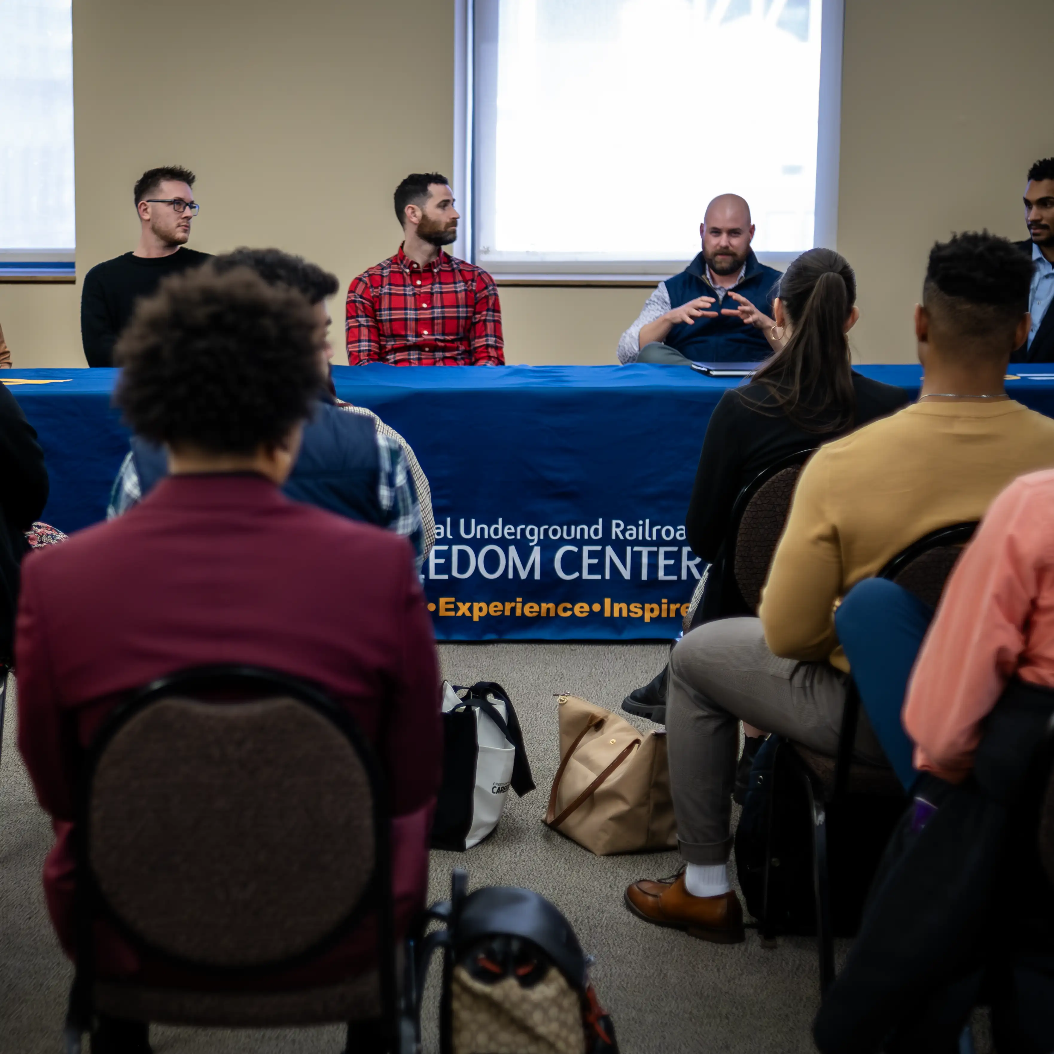 Students listening to professionals sharing experiences at a non-profit organization