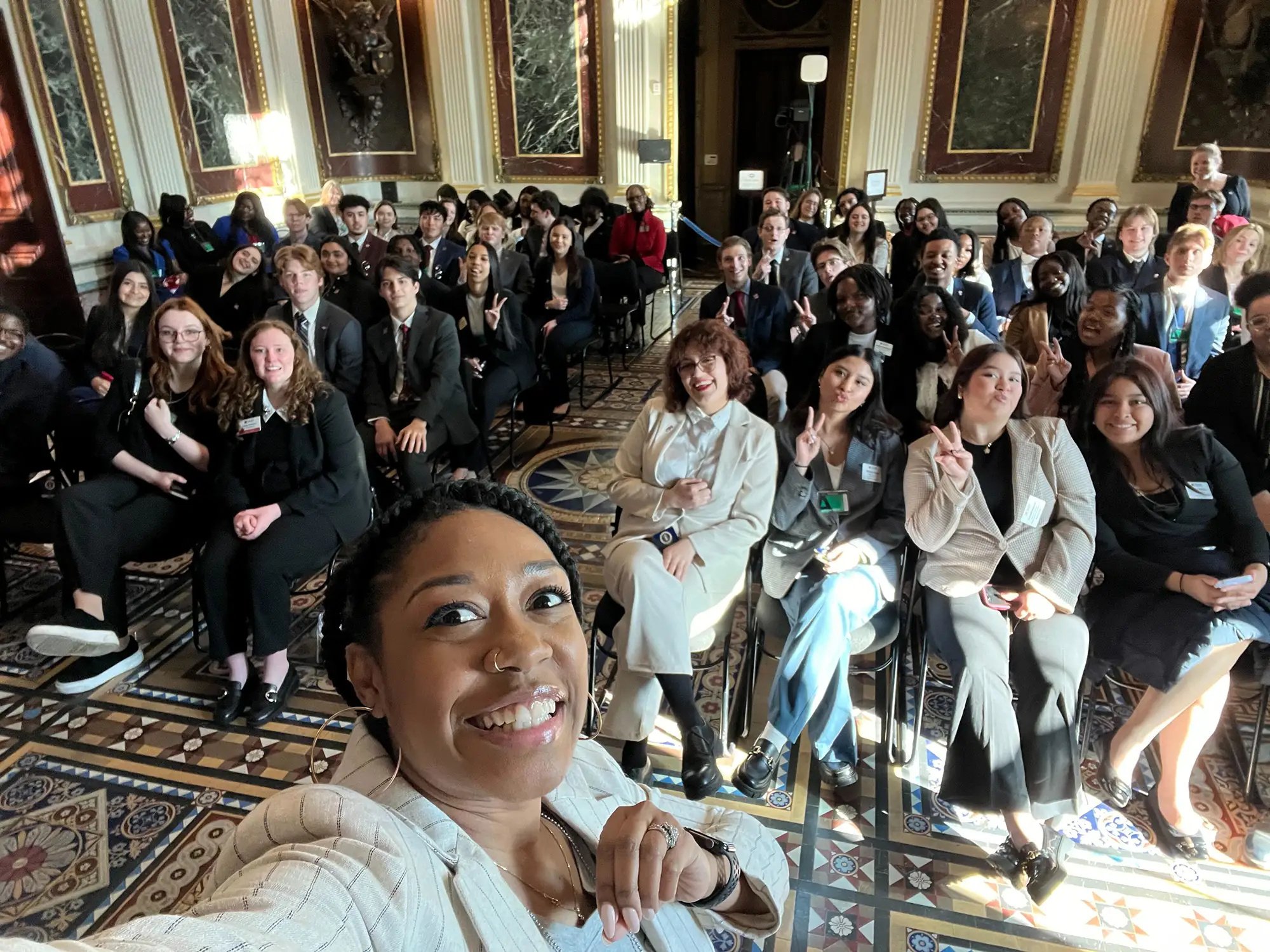 Miami students in a relaxed pose at Washington, D.C.