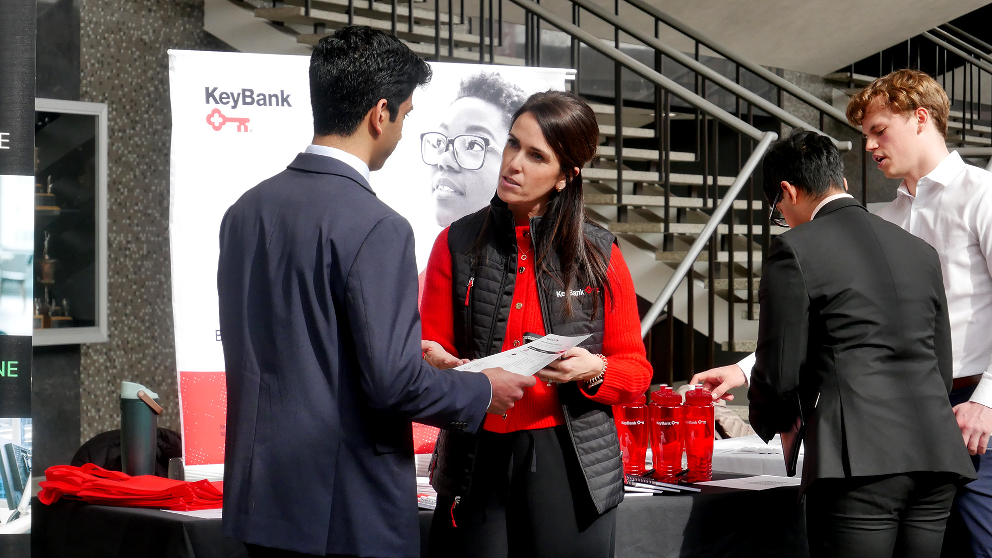 A KeyBank representative speaks to a student at a career fair.
