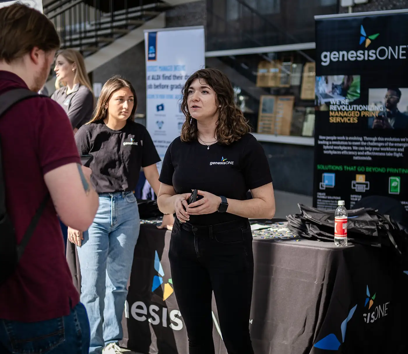 A recruiter from Genesis One speaking with a Miami student