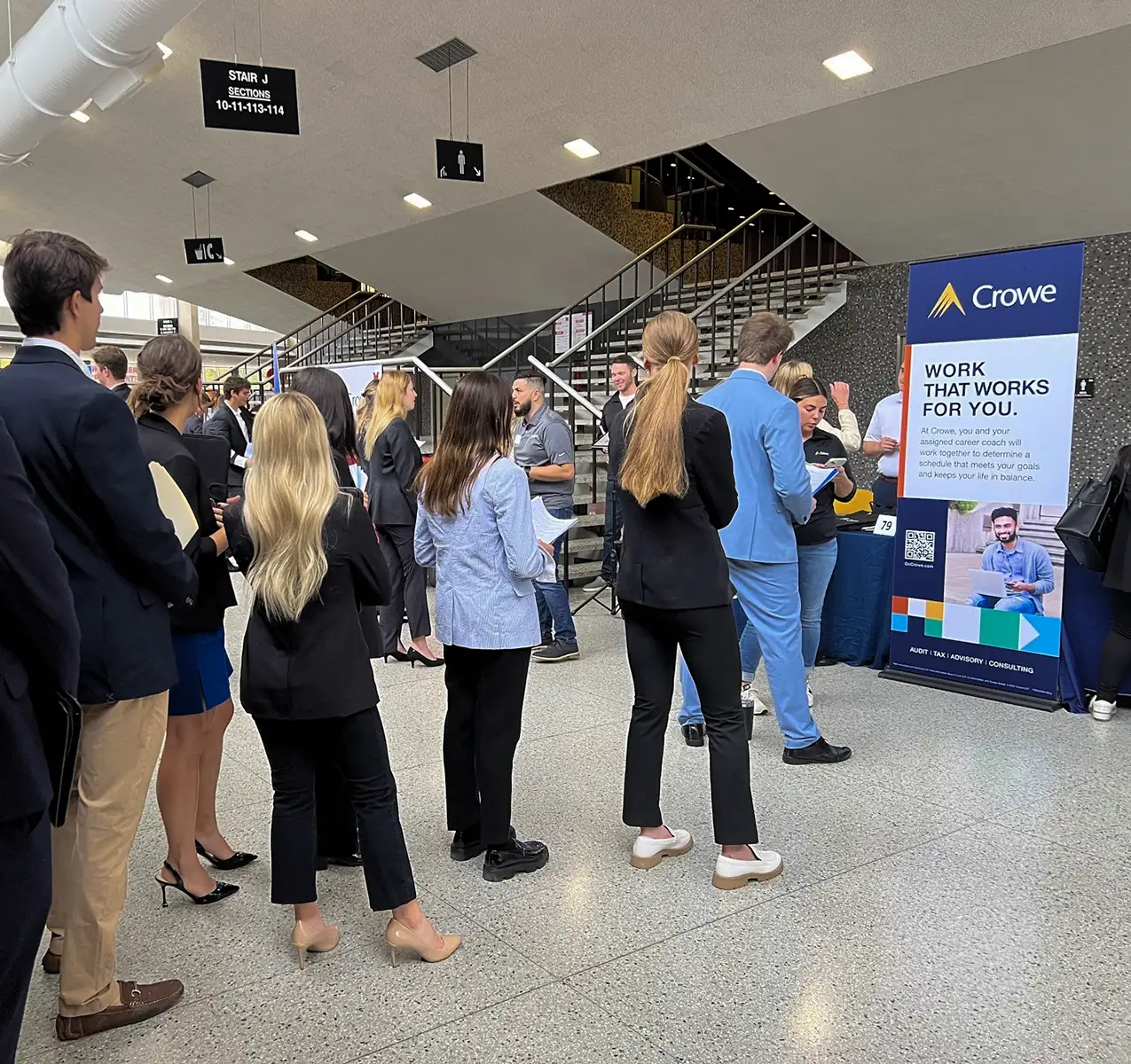 A line of students waiting to speak with a Crowe Career Partner