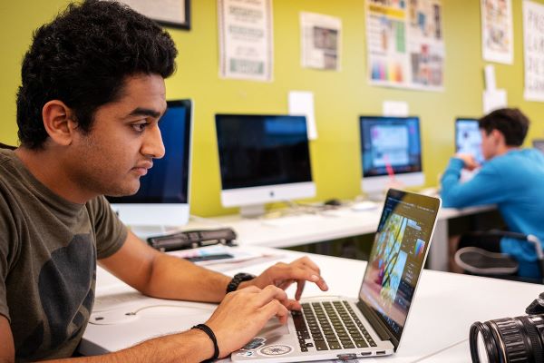 Male student reviewing information on a computer.