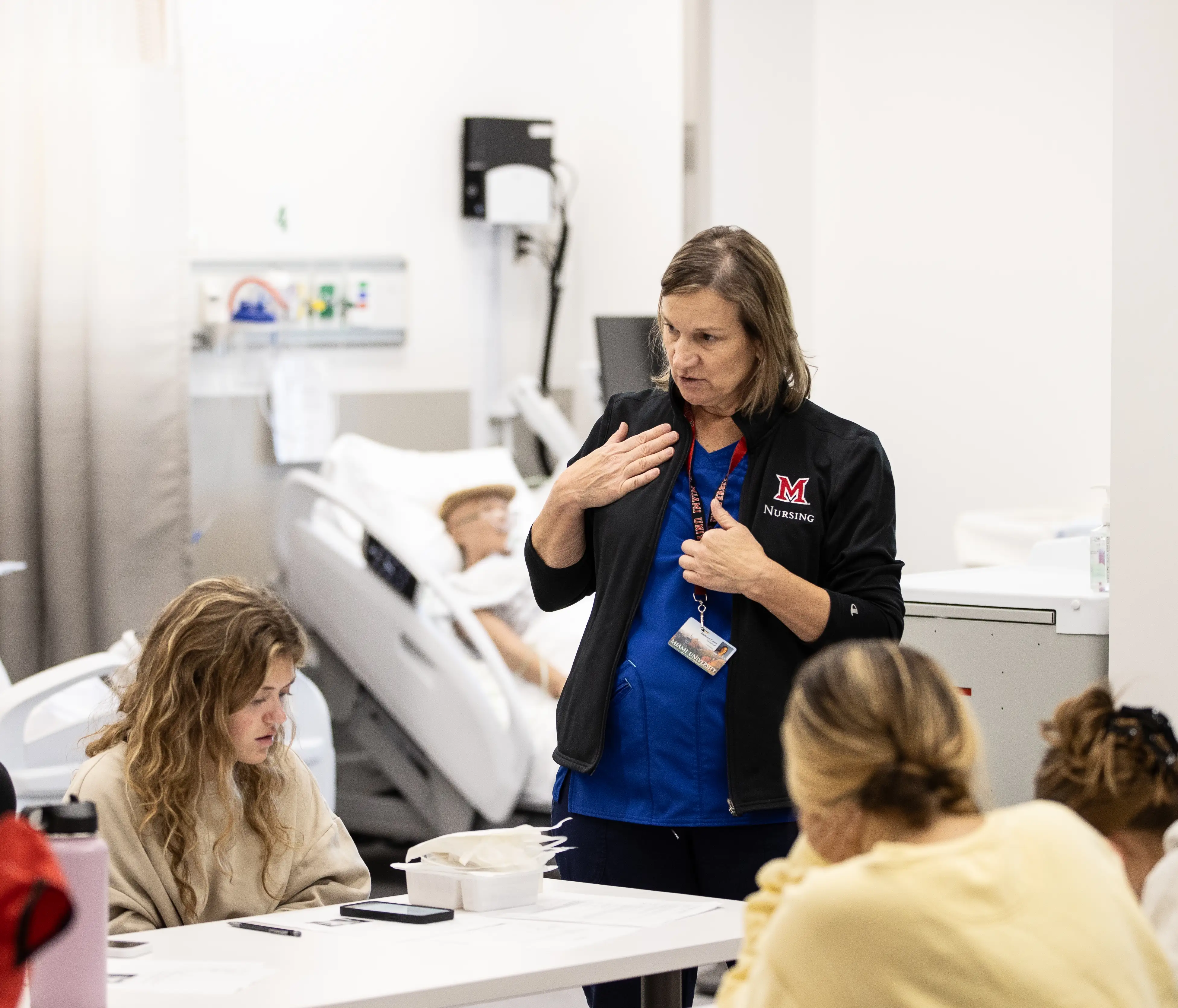 Miami faculty engaging with students in the nursing program