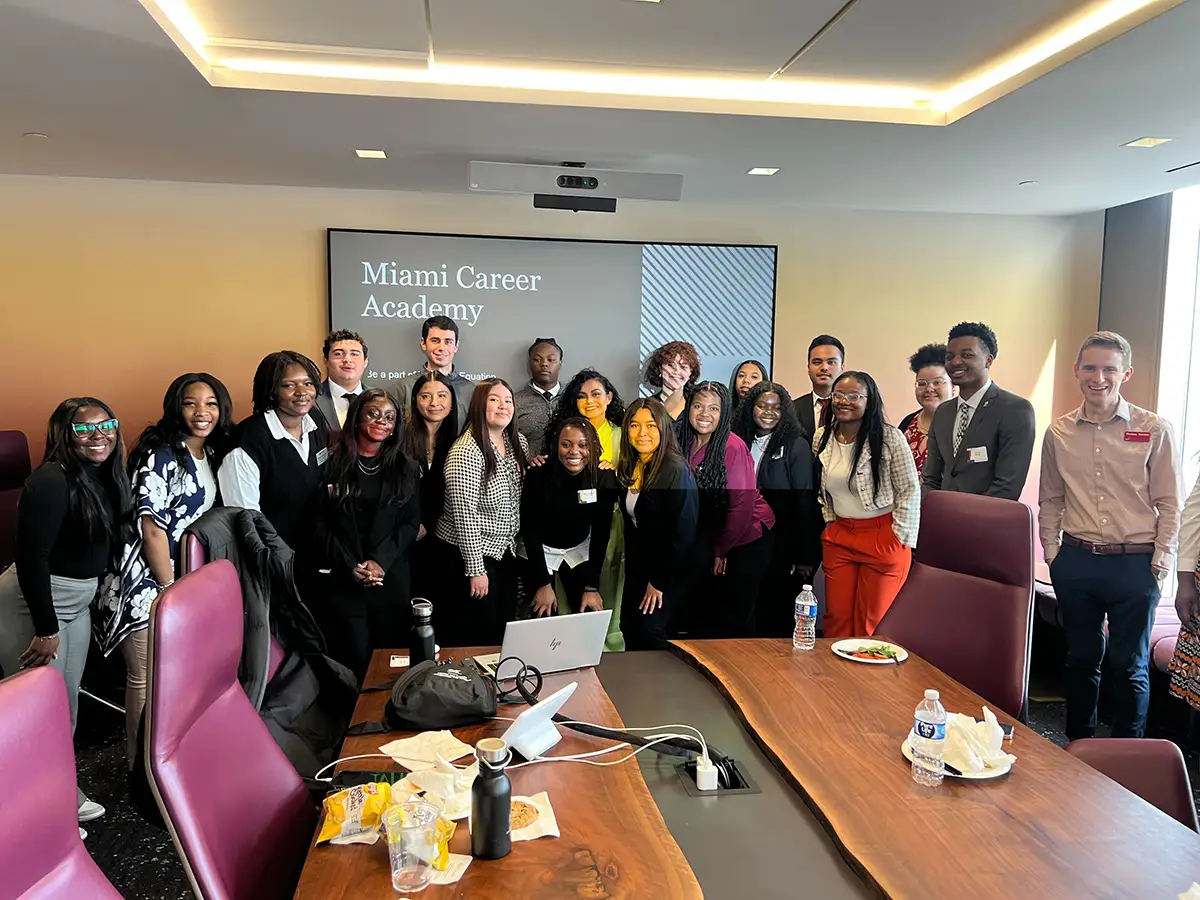 Miami students standing in a meeting room