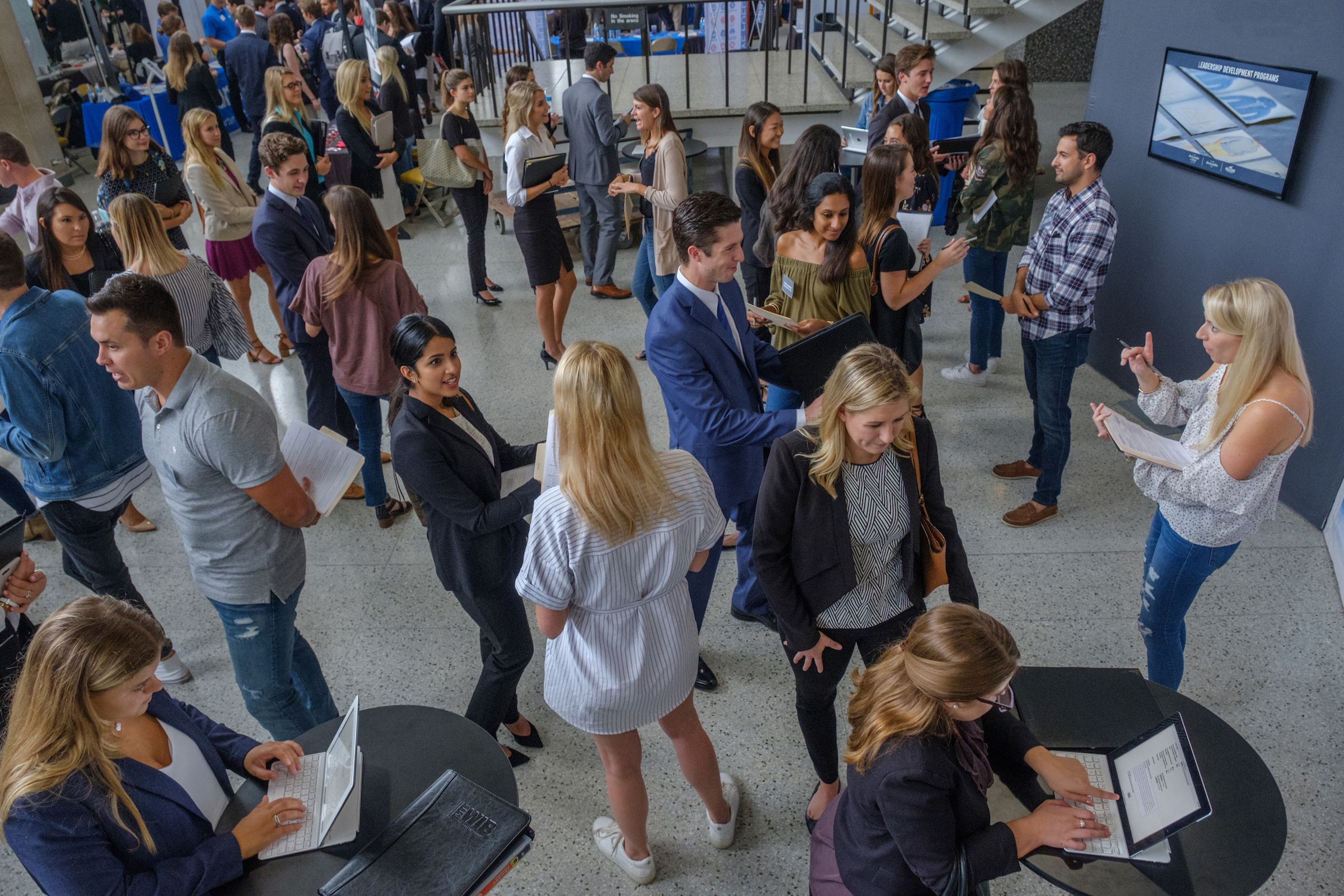 Students and employers crowd the Millet Hall concourse during a career fair.