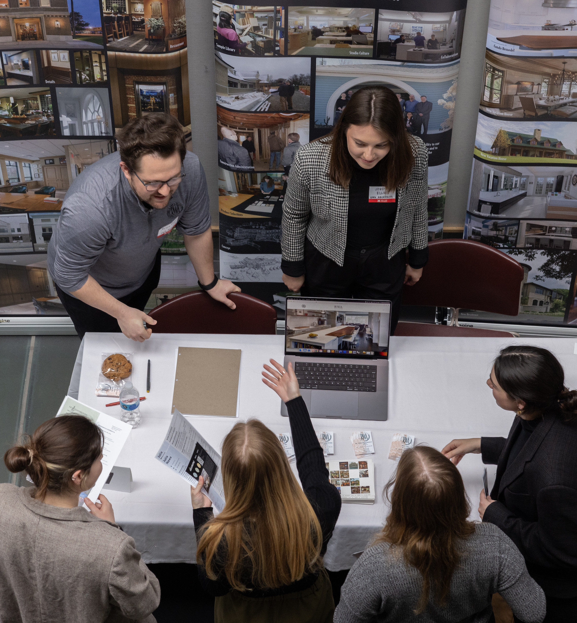 For students speak with two employers at a career fair.