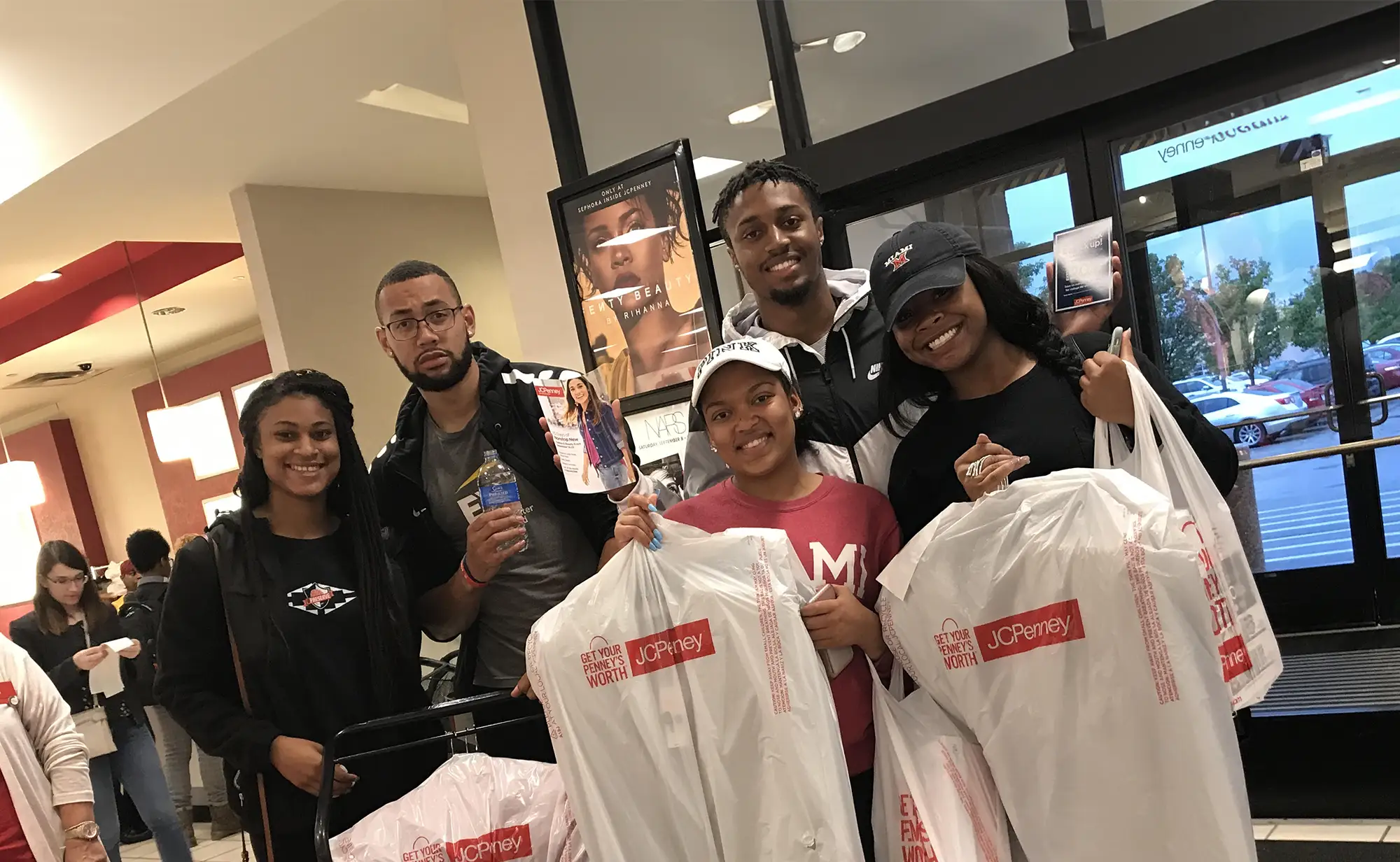 students holding recently purchased professional attire