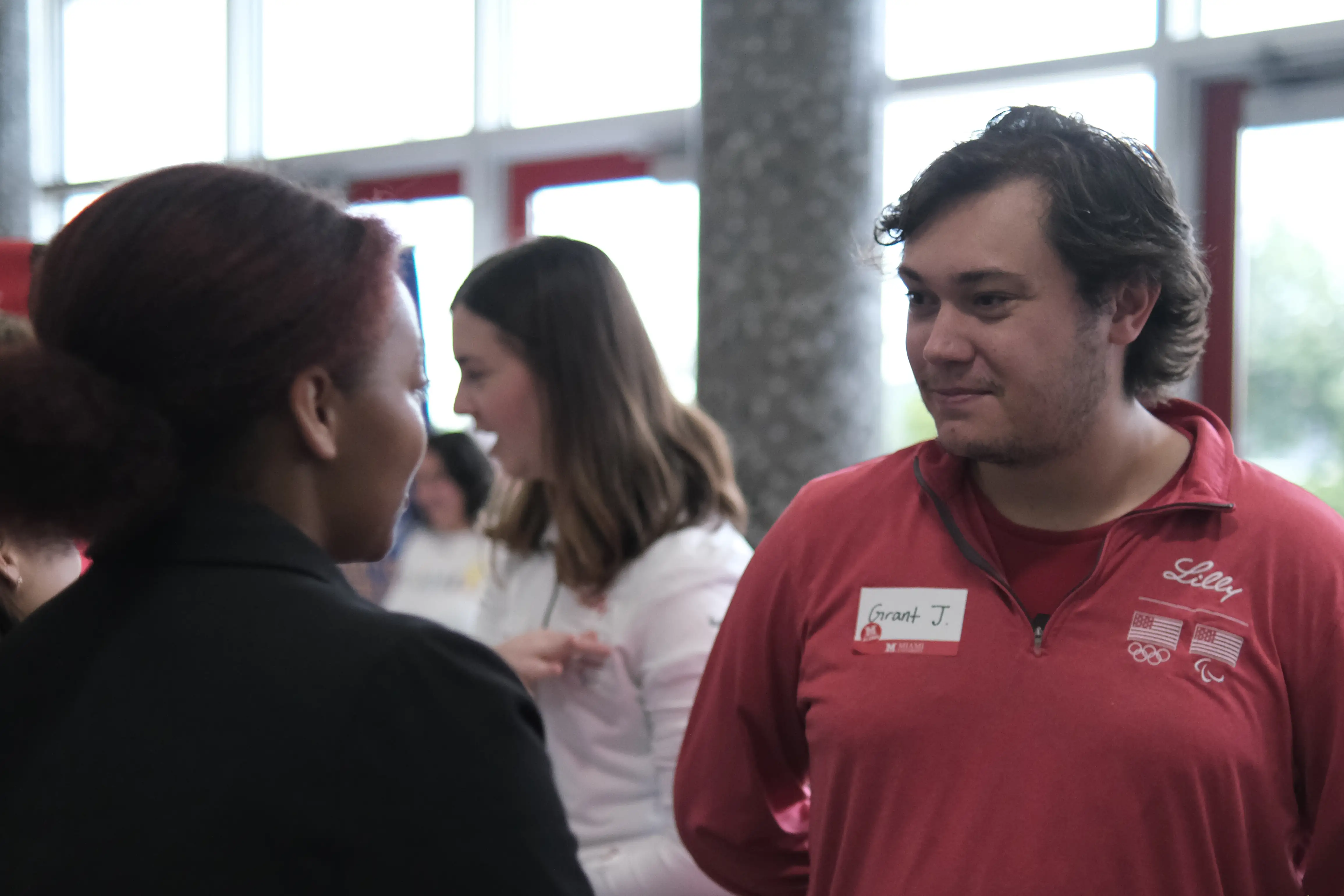 Eli LillyEmployer networking with Miami student at the STEM Career and Internship Fair