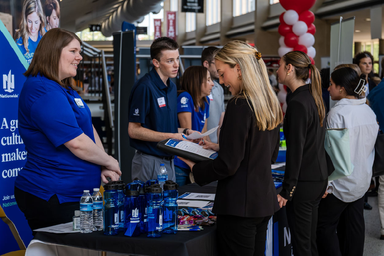 Miami student speaking with an employer at Career Fair