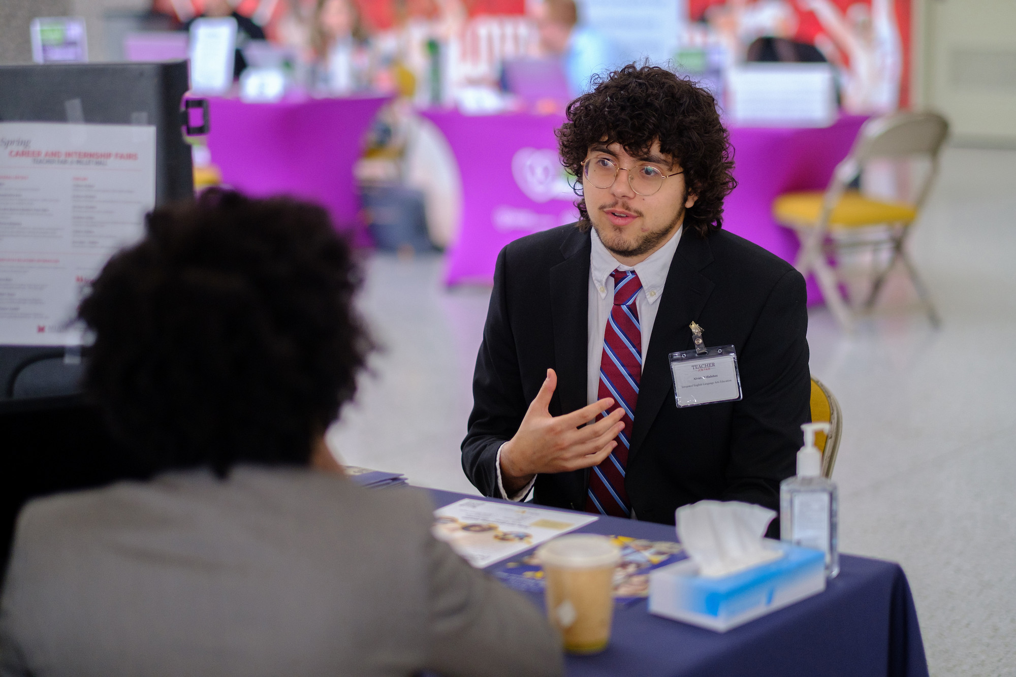 A student interviews with an employer following a career fair.