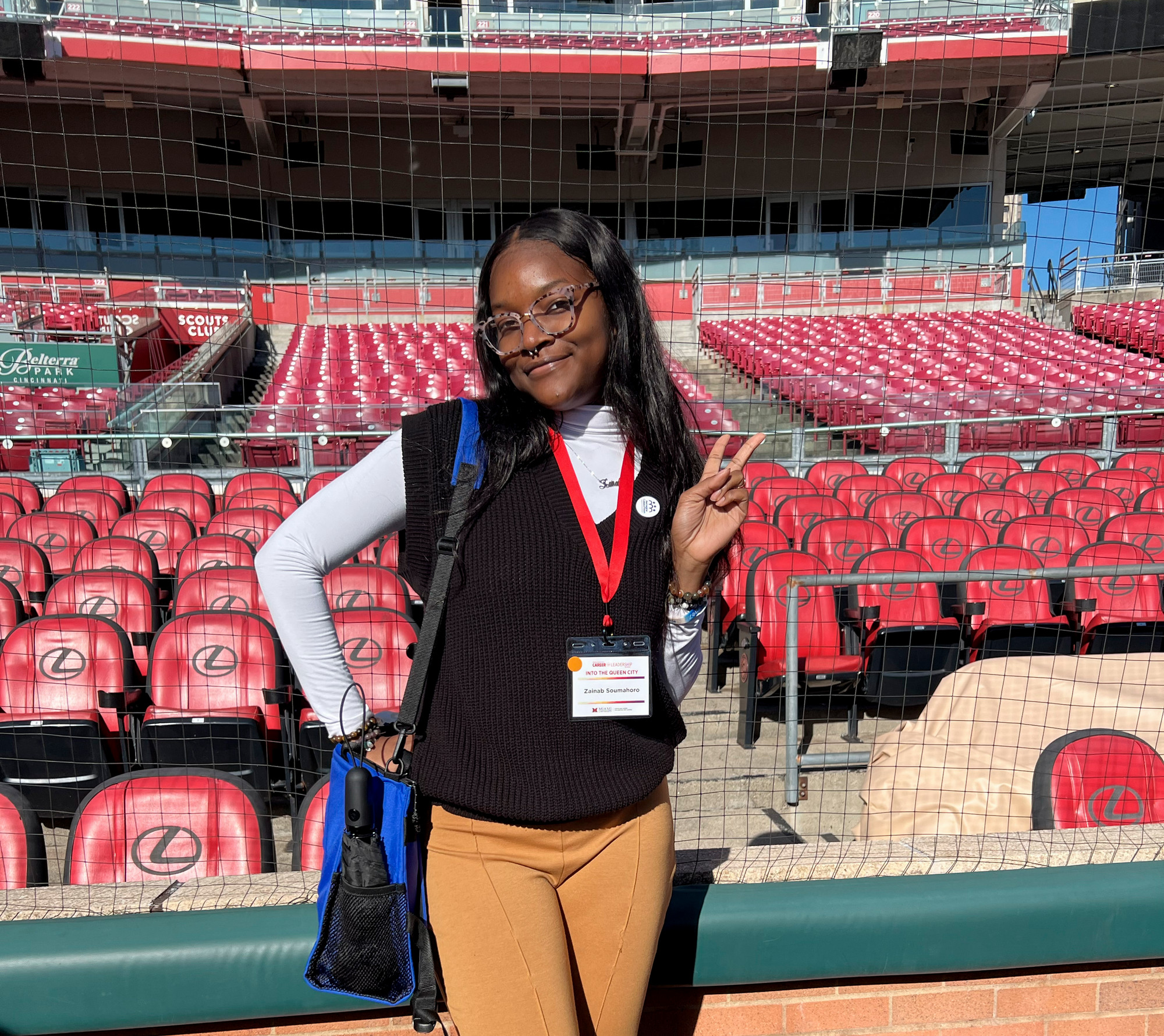 A student poses for a picture on the field at the Great American Ball Park.