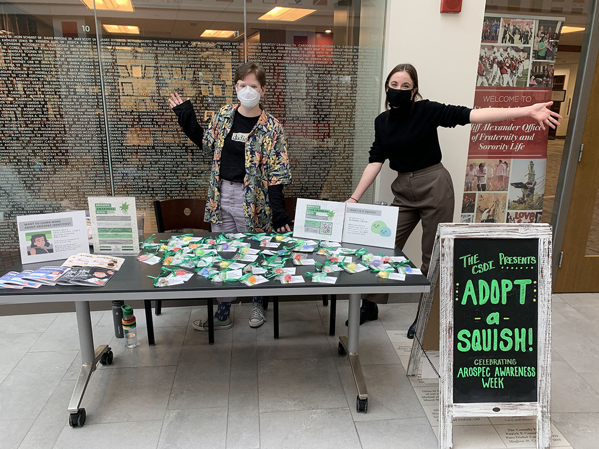 Two people standing behind a table with aerospec material.