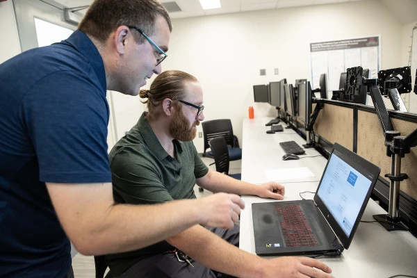 two faculty members meeting by computer