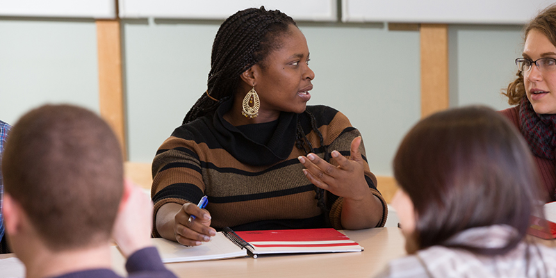 Graduate students in class with professor Emily Legg